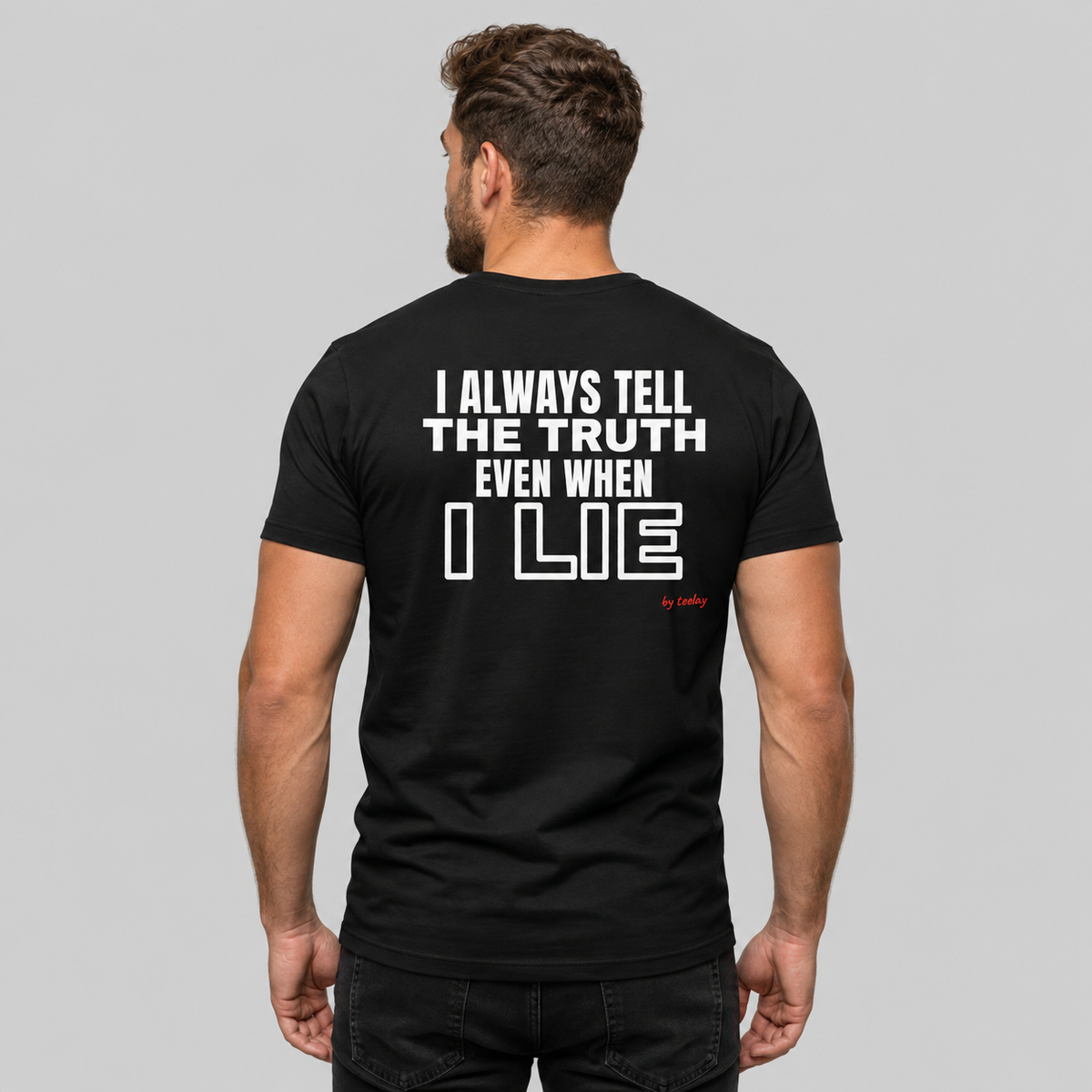 Man from behind wearing a black t shirt with I Always Tell The Truth Even When I Lie printed on the back