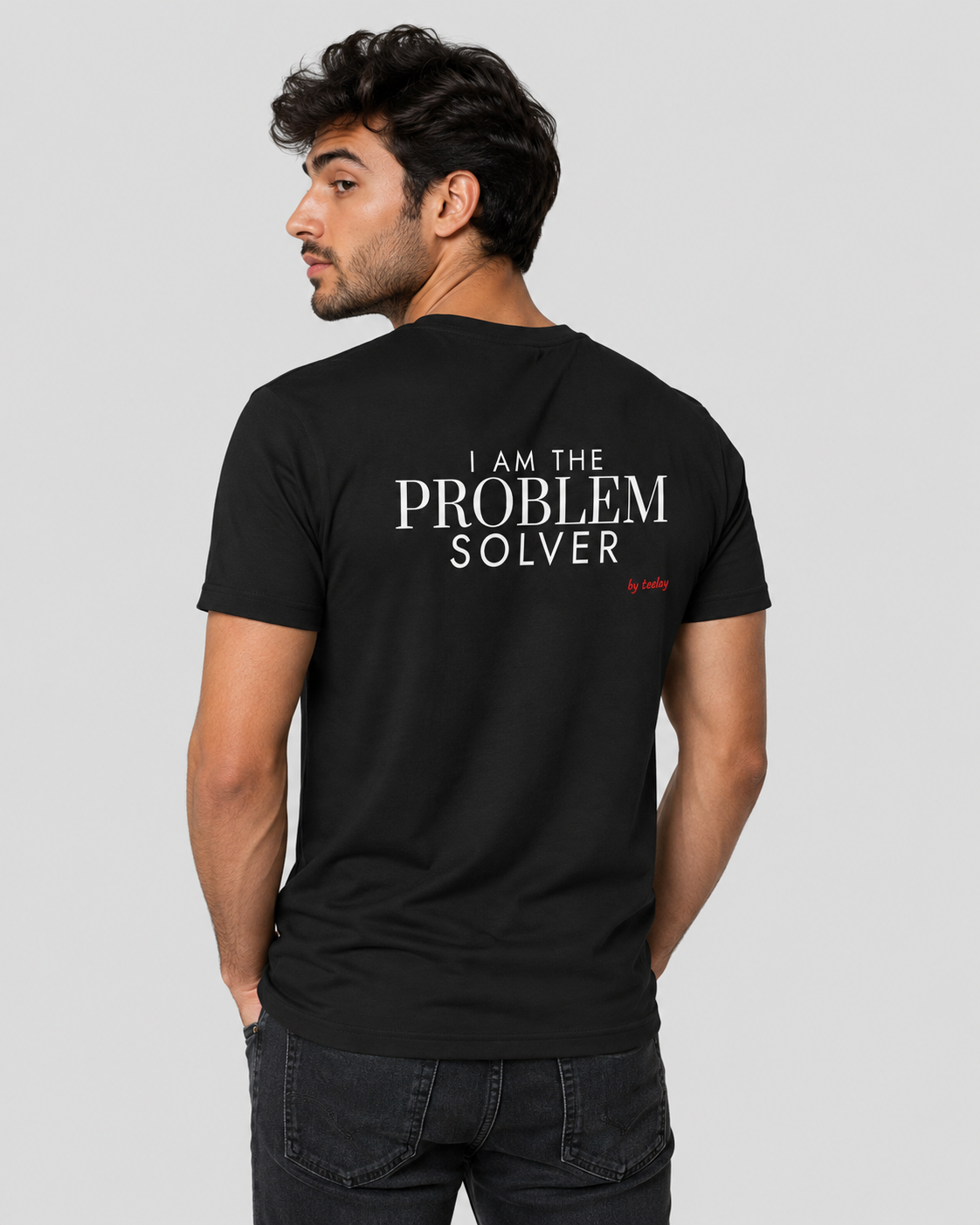 Man from behind wearing a black t shirt with I Am The Problem Solver printed on the back