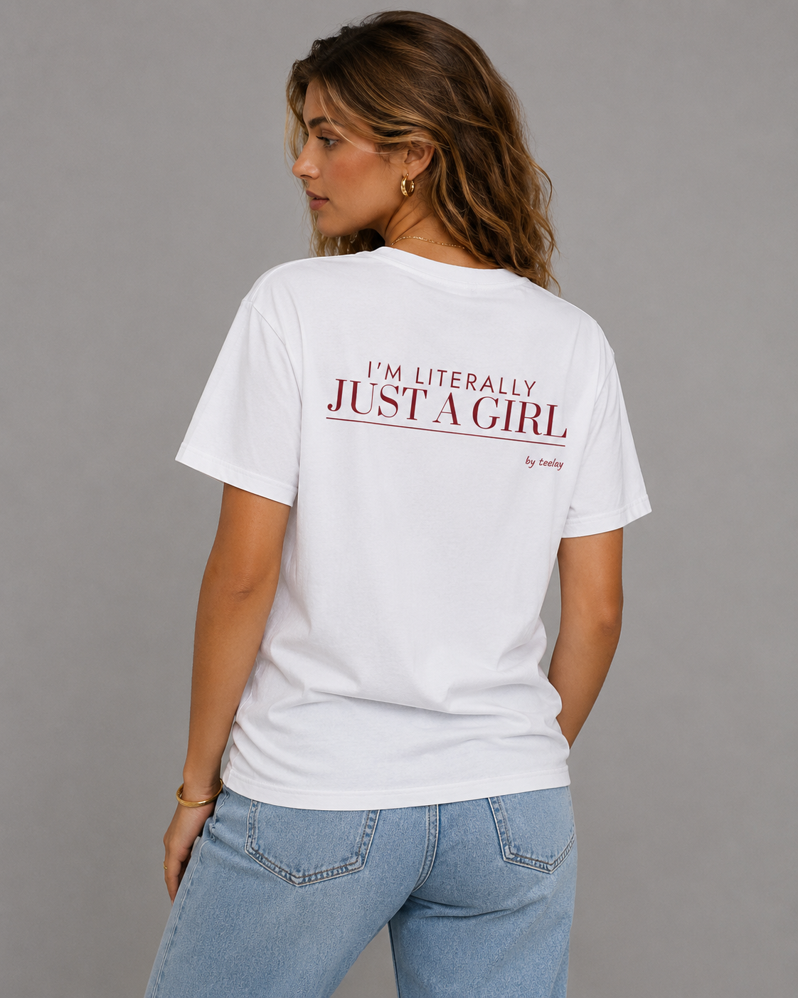 Woman from behind wearing a white t shirt with I'm Literally Just A Girl printed on the back