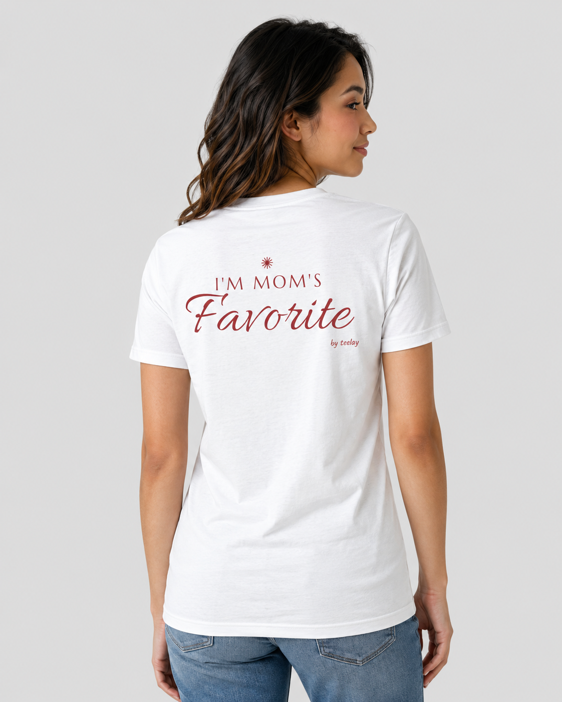 Woman from behind wearing a white t shirt with I'm Mom's Favorite printed on the back