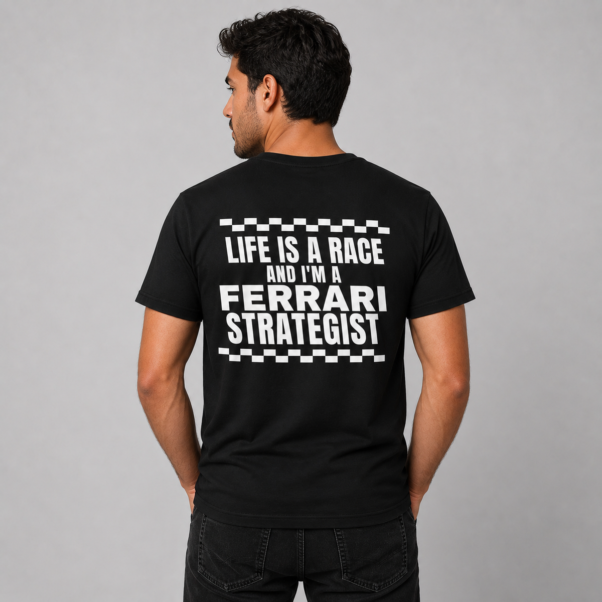 Man from behind wearing a black t shirt with Life Is A Race And I'm A Strategist printed on the back