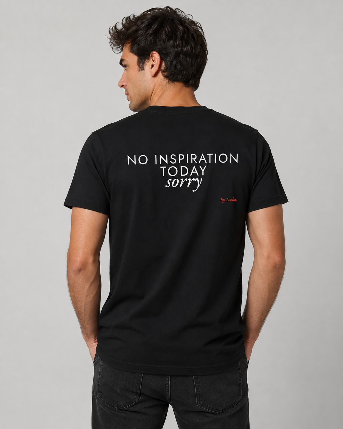 Man from behind wearing a black t shirt with No Inspiration Today Sorry printed on the back