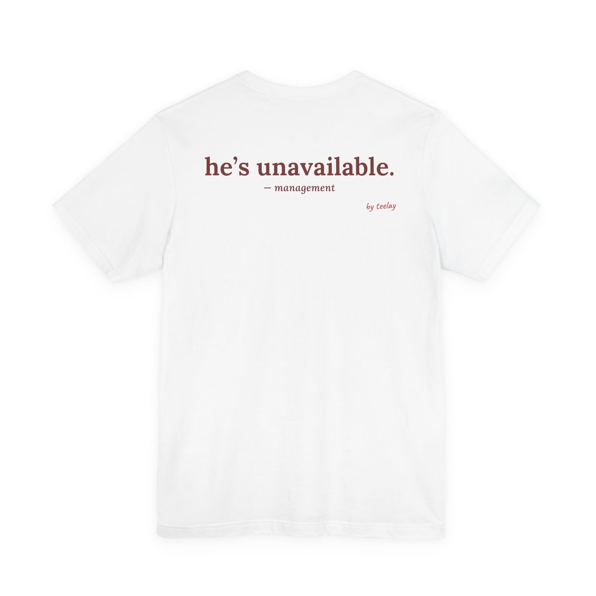 Woman from behind wearing a white oversized t shirt with "He's Unavailable. — Management" printed on the back