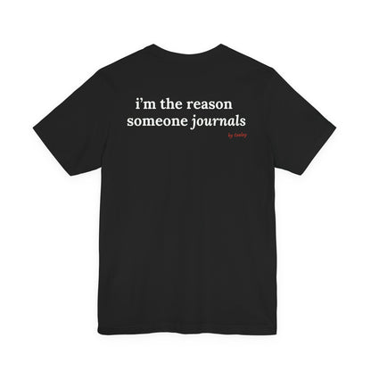 Woman from behind wearing a black oversized t shirt with "I'm The Reason Someone Journals" printed on the back