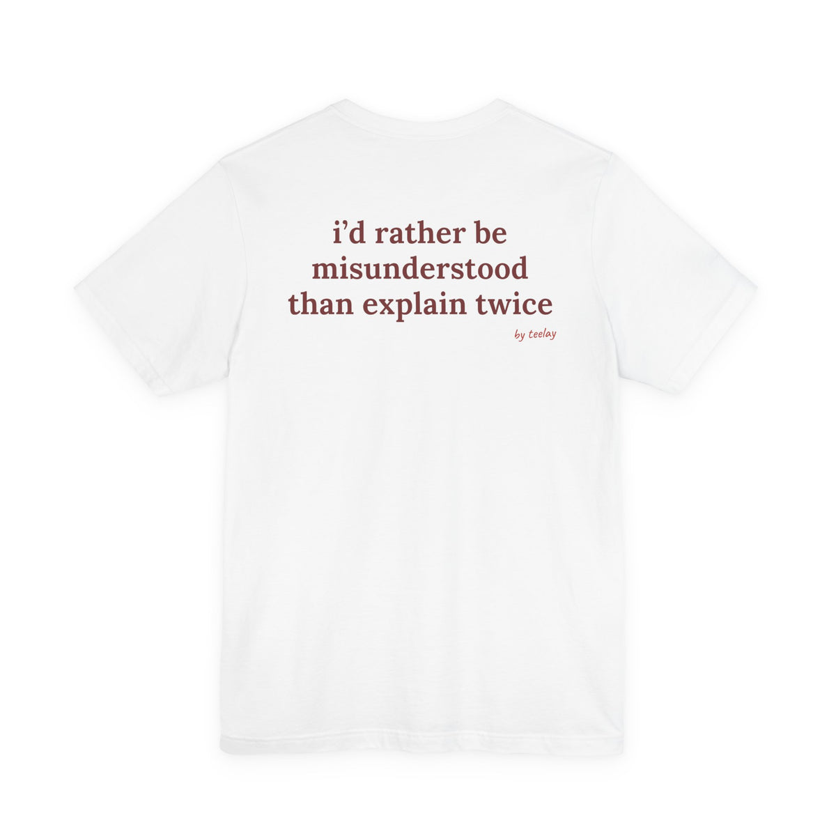 Woman from behind wearing a white oversized t shirt with "I'd Rather Be Misunderstood Than Explain Twice" printed on the back