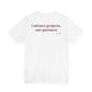 Woman from behind wearing a white oversized t shirt with "I Attract Projects, Not Partners" printed on the back