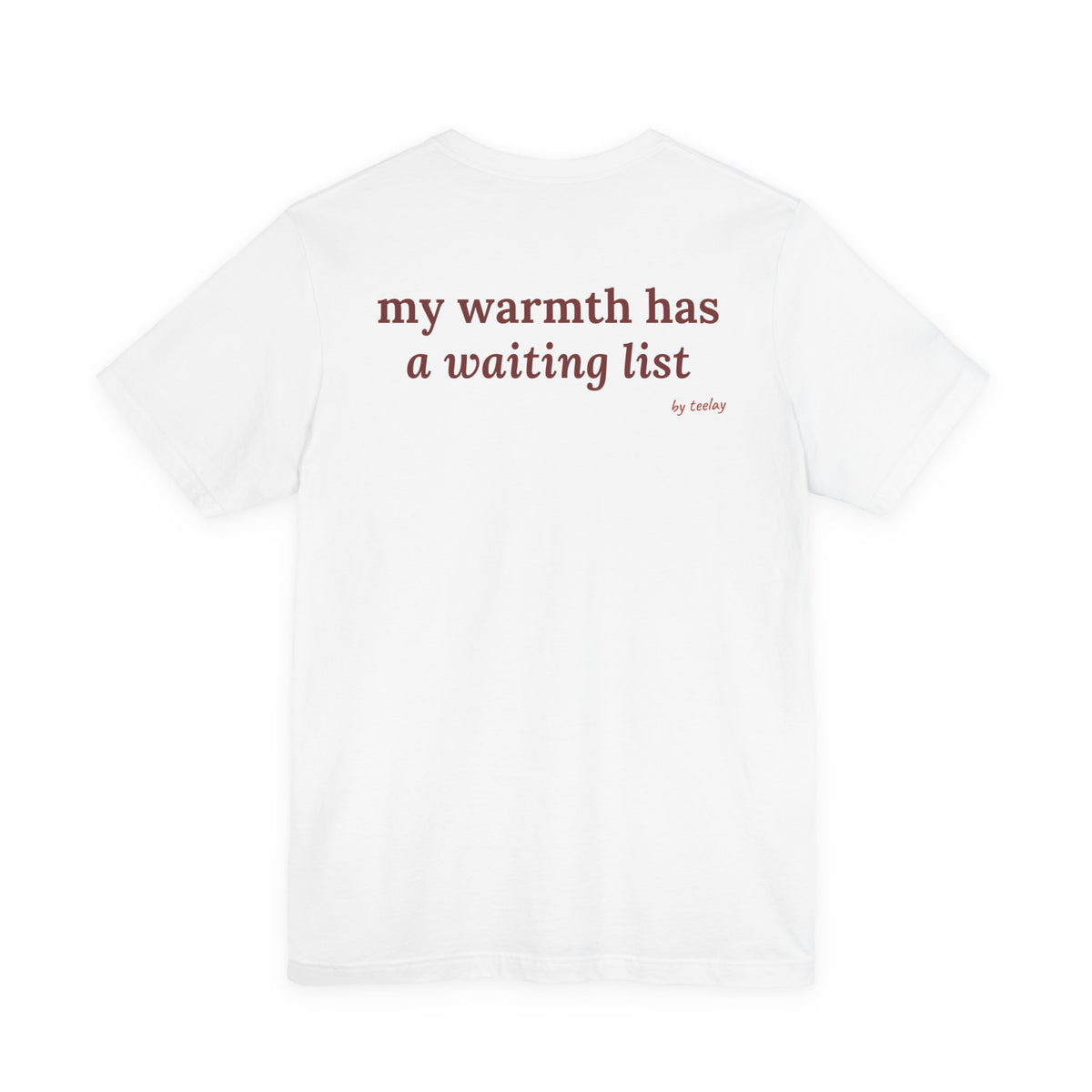 Woman from behind wearing a white oversized t shirt with "My Warmth Has A Waiting List" printed on the back