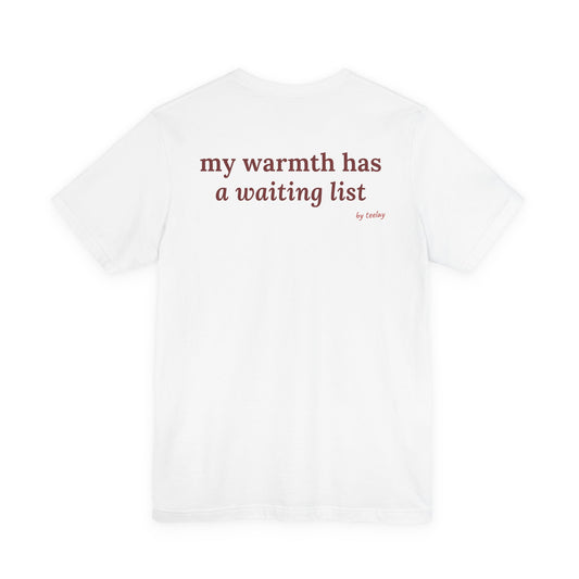 Woman from behind wearing a white oversized t shirt with "My Warmth Has A Waiting List" printed on the back
