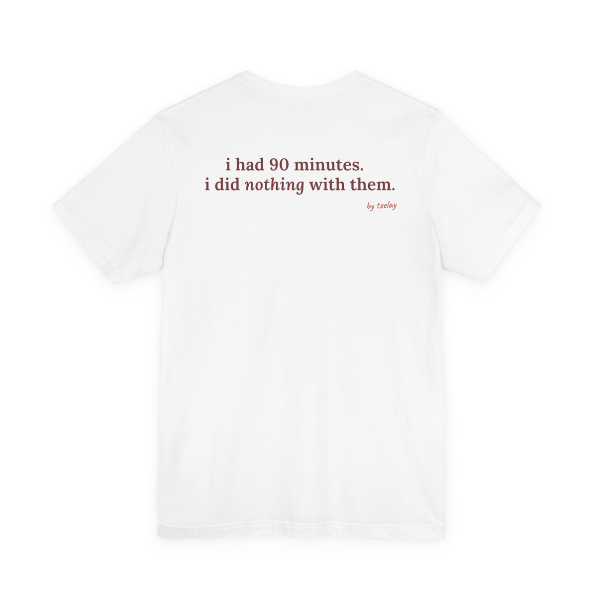 Woman from behind wearing a white oversized t shirt with "I Had 90 Minutes. I Did Nothing With Them." printed on the back