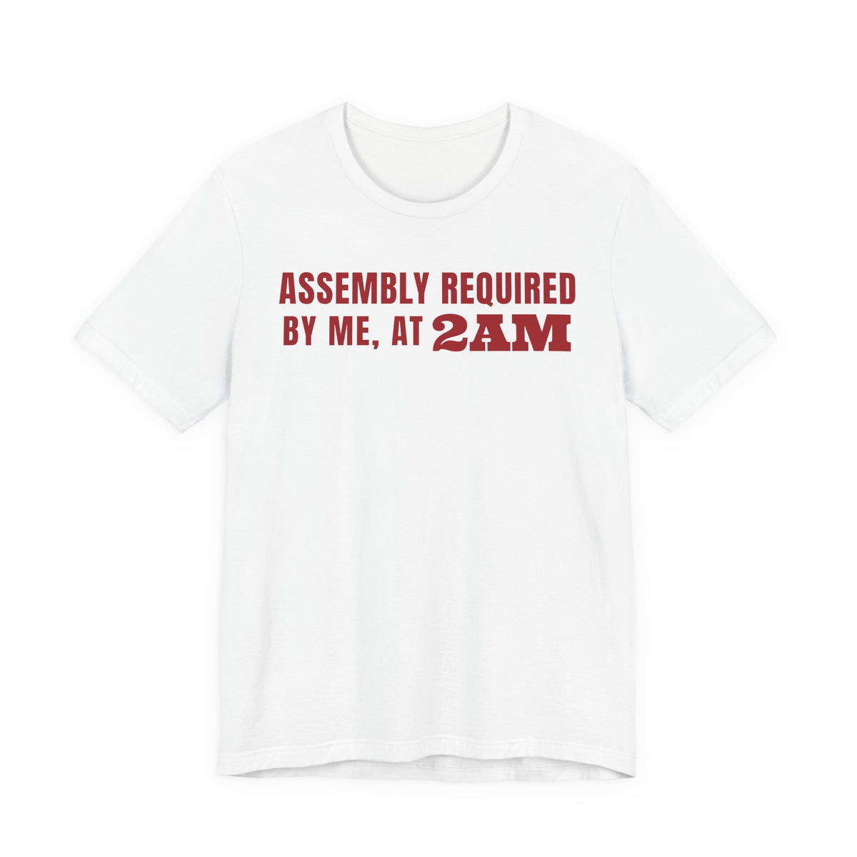 Front of a white t shirt with Assembly Required By Me, At 2AM printed in red