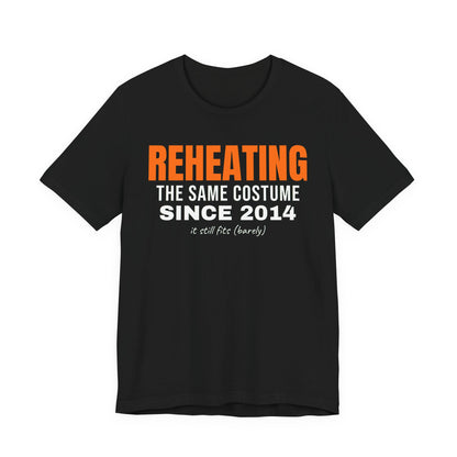 Black oversized t shirt with Reheating The Same Costume Since 2014 printed in orange on the front