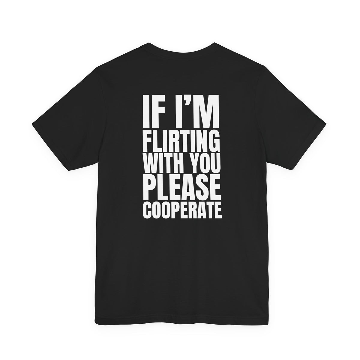 Woman from behind wearing a black oversized t shirt with "If I'm Flirting With You, Please Cooperate" printed on the back, bold block design