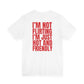 Woman from behind wearing a white oversized t shirt with "I'm Not Flirting, I'm Just Hot And Friendly" printed on the back, bold block design