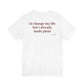 Woman from behind wearing a white oversized t shirt with "I'd Change My Life But I Already Made Plans" printed on the back