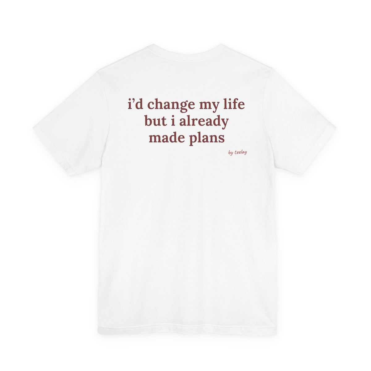 Woman from behind wearing a white oversized t shirt with "I'd Change My Life But I Already Made Plans" printed on the back