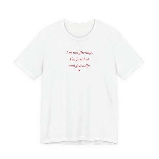Woman wearing a white oversized t shirt with "I'm Not Flirting, I'm Just Hot And Friendly" printed on the front, fashion italic design
