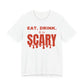 White oversized t shirt with Eat. Drink. & Be Scary printed in red on the front