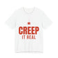 White oversized t shirt with Creep It Real printed in red on the front