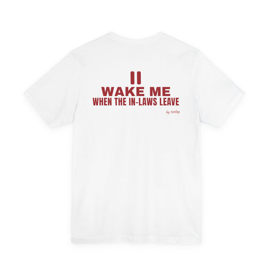 Back of a white t shirt with Wake Me When The In-Laws Leave printed in red