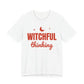 White oversized t shirt with Witchful Thinking printed in red on the front