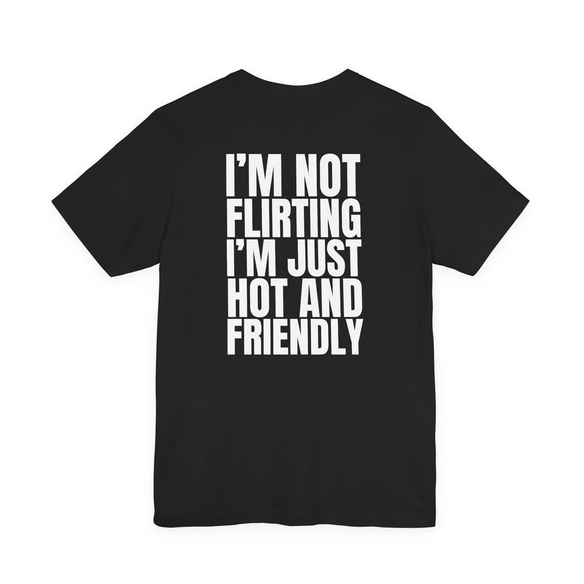 Woman from behind wearing a black oversized t shirt with "I'm Not Flirting, I'm Just Hot And Friendly" printed on the back, bold block design