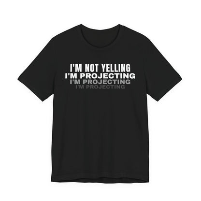 Front of a black t shirt with I'm Not Yelling I'm Projecting printed in white