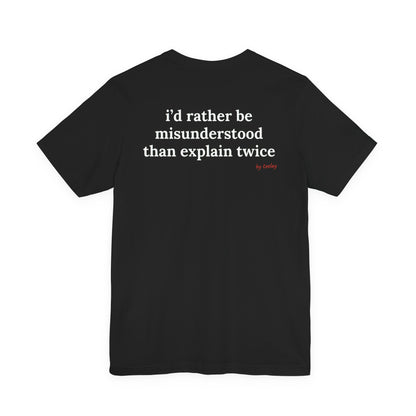Woman from behind wearing a black oversized t shirt with "I'd Rather Be Misunderstood Than Explain Twice" printed on the back