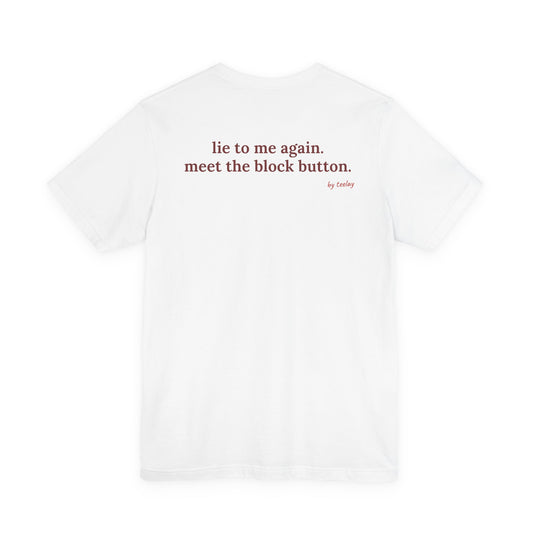 Woman from behind wearing a white oversized t shirt with "Lie To Me Again. Meet The Block Button." printed on the back