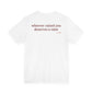 Woman from behind wearing a white oversized t shirt with "Whoever Raised You Deserves A Raise" printed on the back