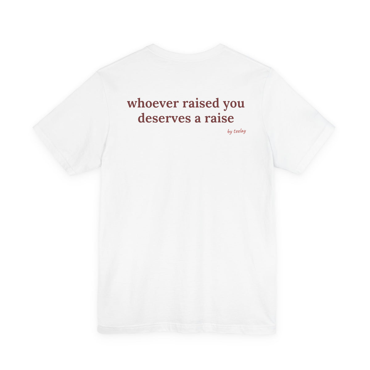Woman from behind wearing a white oversized t shirt with "Whoever Raised You Deserves A Raise" printed on the back