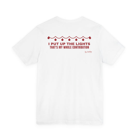 Back of a white t shirt with I Put Up The Lights That's My Whole Contribution printed in red