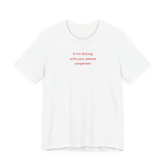 Woman wearing a white oversized t shirt with "If I'm Flirting With You, Please Cooperate" printed on the front, clean type design