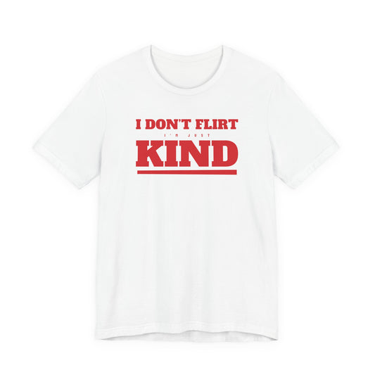 Woman wearing a white oversized t shirt with "I Don't Flirt, I'm Just Kind" printed on the front, varsity design