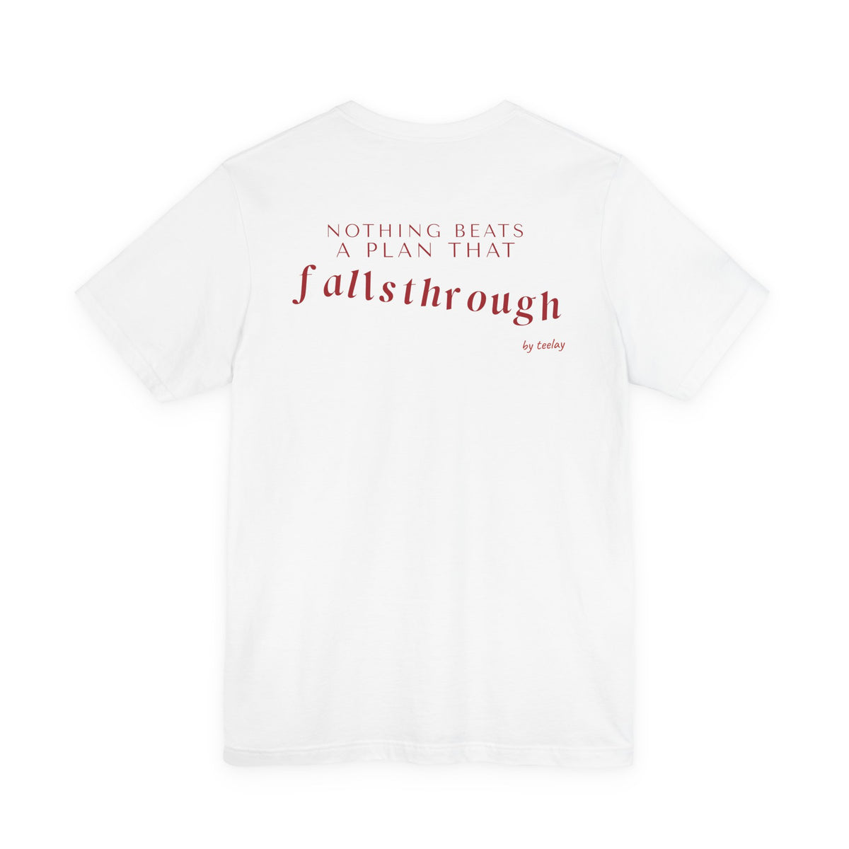 Back of a white t shirt with Nothing Beats A Plan That Falls Through printed in red