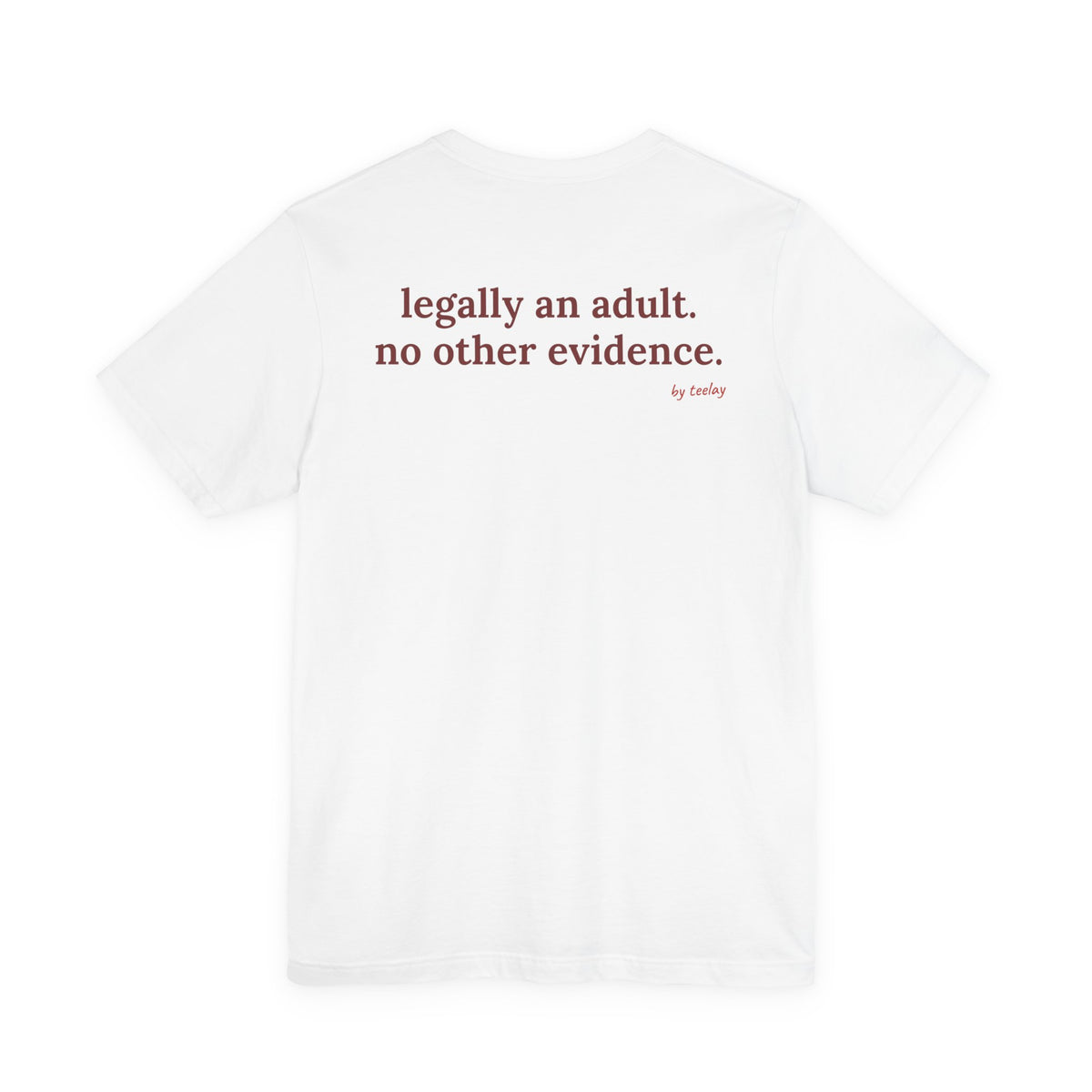 Woman from behind wearing a white oversized t shirt with "Legally An Adult. No Other Evidence." printed on the back