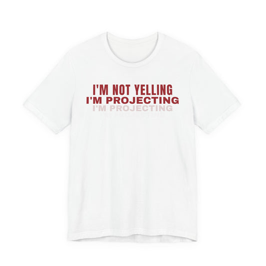 Front of a white t shirt with I'm Not Yelling I'm Projecting printed in red