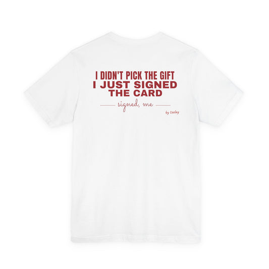 Back of a white t shirt with I Didn't Pick The Gift I Just Signed The Card printed in red