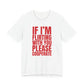 Woman wearing a white oversized t shirt with "If I'm Flirting With You, Please Cooperate" printed on the front, bold block design