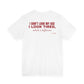 Back of a white t shirt with I Don't Look My Age I Look Tired Which Is Different printed in red