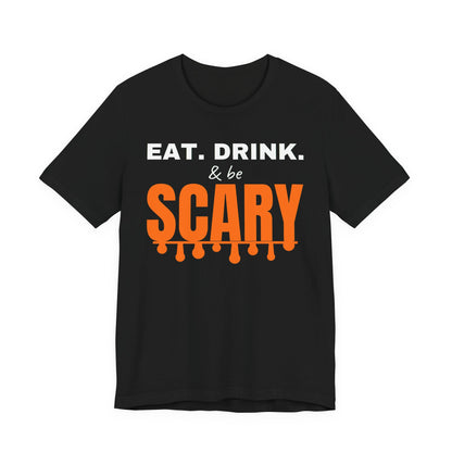Black oversized t shirt with Eat. Drink. & Be Scary printed in orange on the front