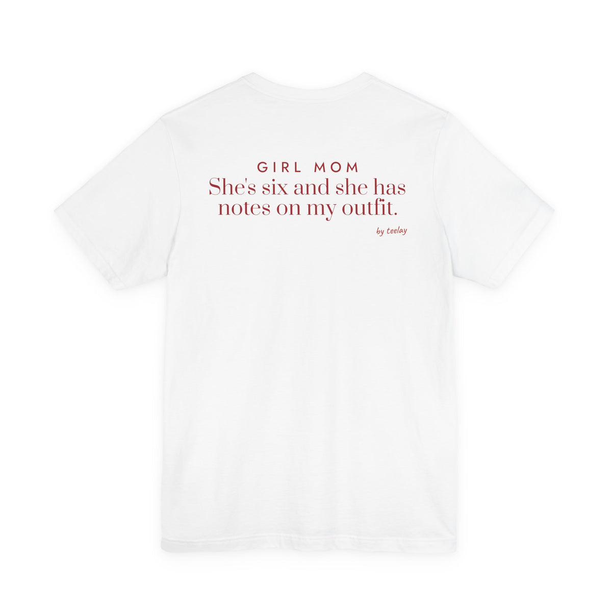 Back of a white t shirt with Girl Mom: She's Six And She Has Notes On My Outfit printed in red