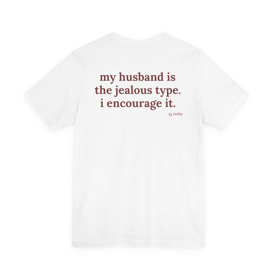 Woman from behind wearing a white oversized t shirt with "My Husband Is The Jealous Type. I Encourage It." printed on the back