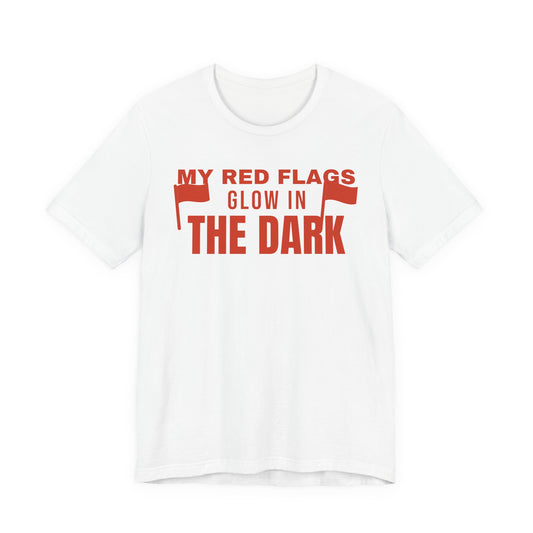 White oversized t shirt with My Red Flags Glow In The Dark printed in red on the front