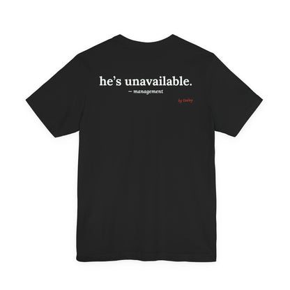 Woman from behind wearing a black oversized t shirt with "He's Unavailable. — Management" printed on the back
