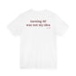 Woman from behind wearing a white oversized t shirt with "Turning 40 Was Not My Idea" printed on the back