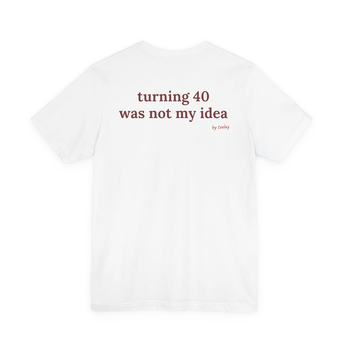 Woman from behind wearing a white oversized t shirt with "Turning 40 Was Not My Idea" printed on the back