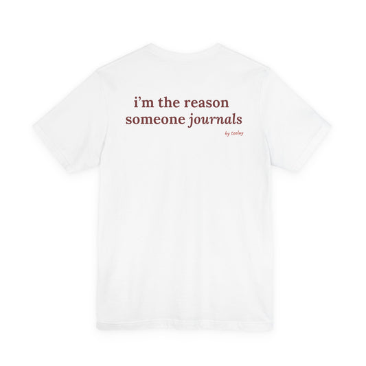 Woman from behind wearing a white oversized t shirt with "I'm The Reason Someone Journals" printed on the back