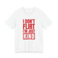 Woman wearing a white oversized t shirt with "I Don't Flirt, I'm Just Kind" printed on the front, knockout bar design
