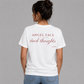 Woman from behind wearing a white t shirt with Angel Face Devil Thoughts printed on the back