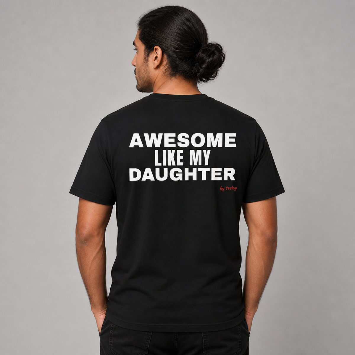 Man from behind wearing a black t shirt with Awesome Like My Daughter printed on the back